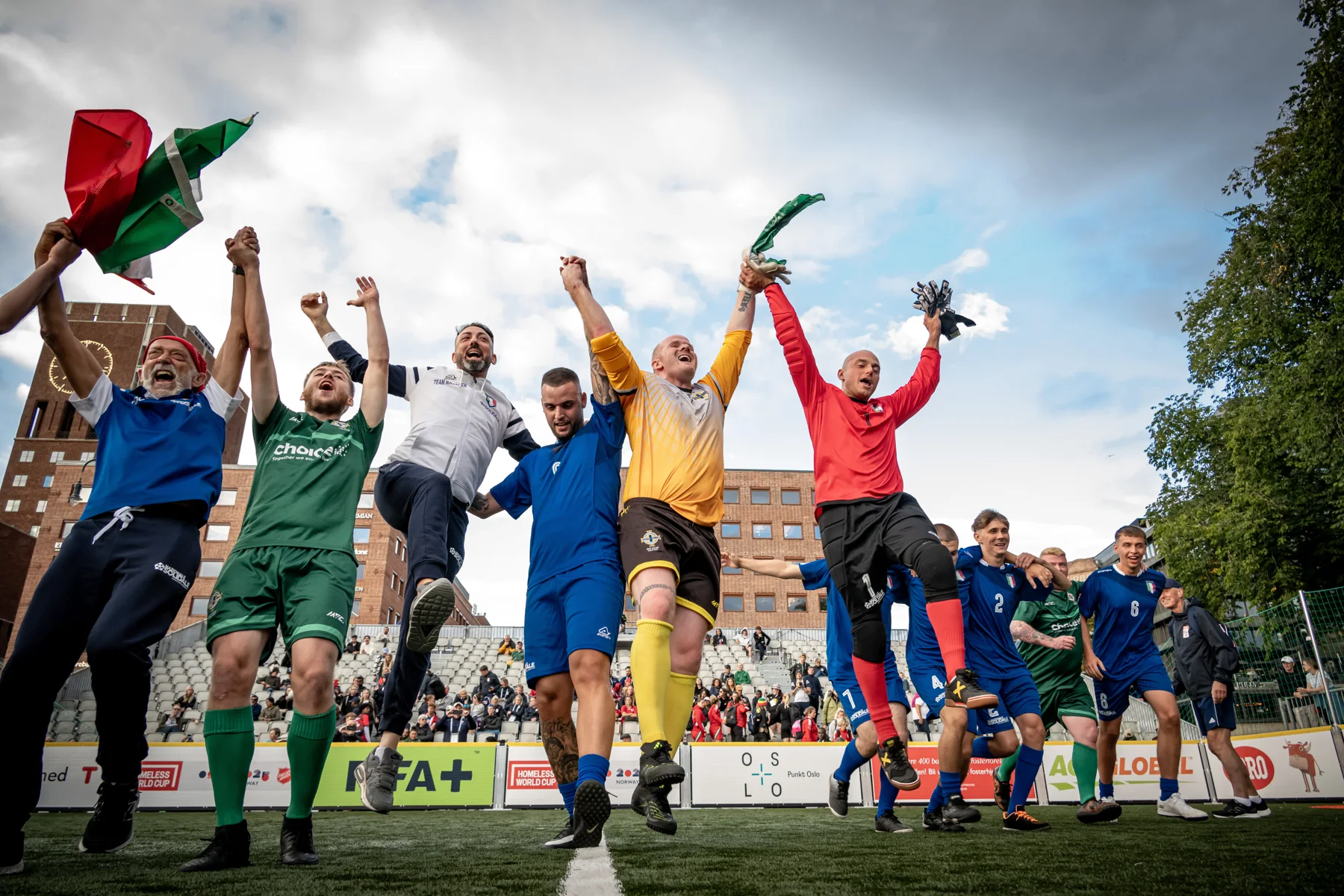 Players celebrate together at the Oslo 2025 Homeless World Cup