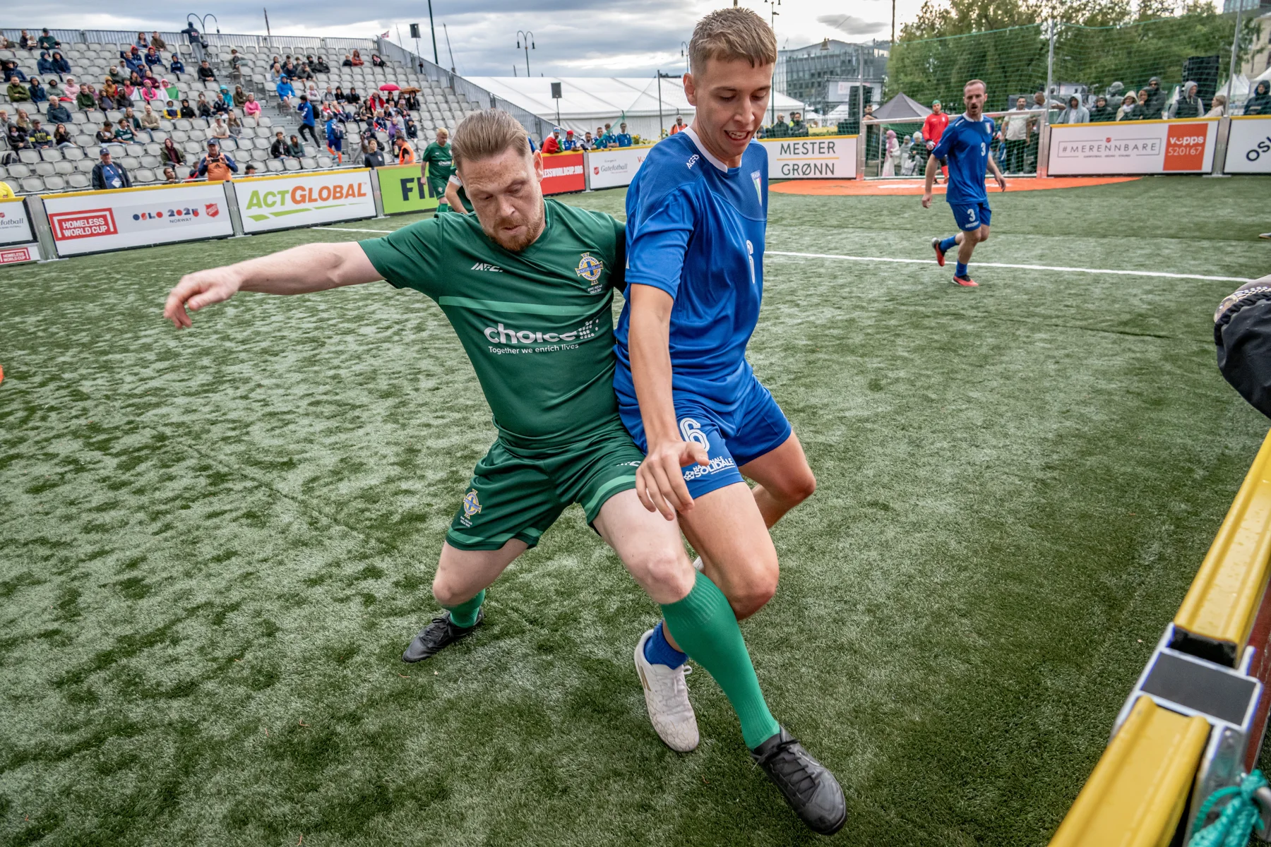 Two players contest the ball during a football match